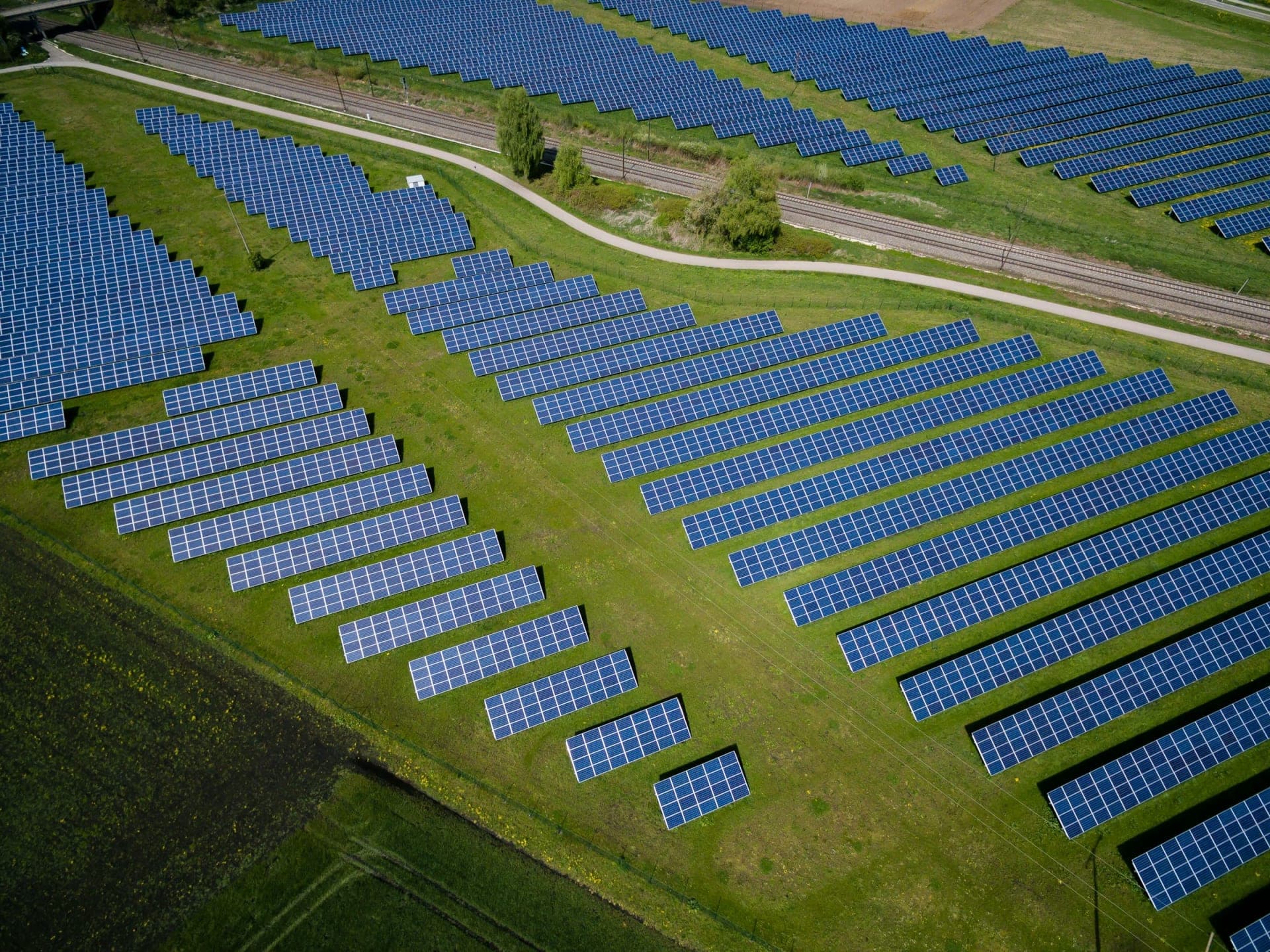 Aerial view of solar panels on green grass field