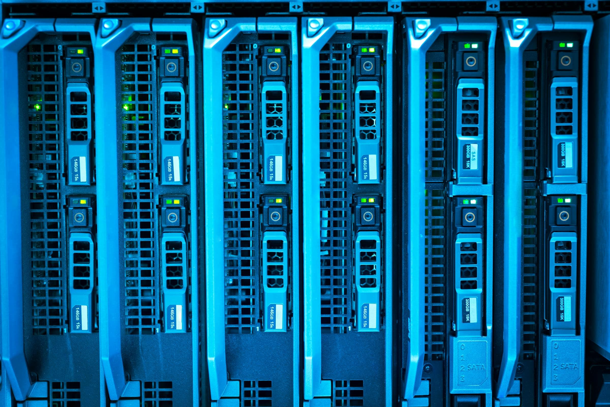Blue-lit server blades in a data center rack