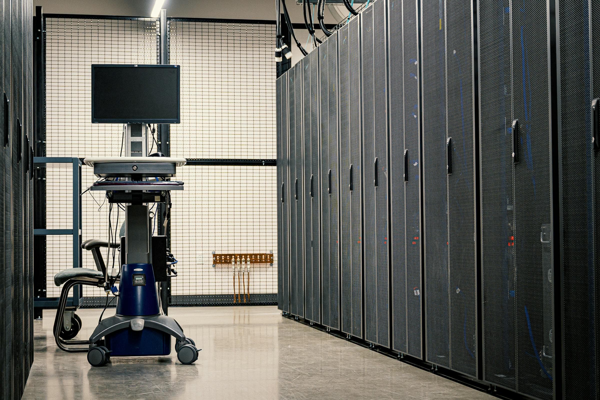 Row of server racks inside a modern data center hall