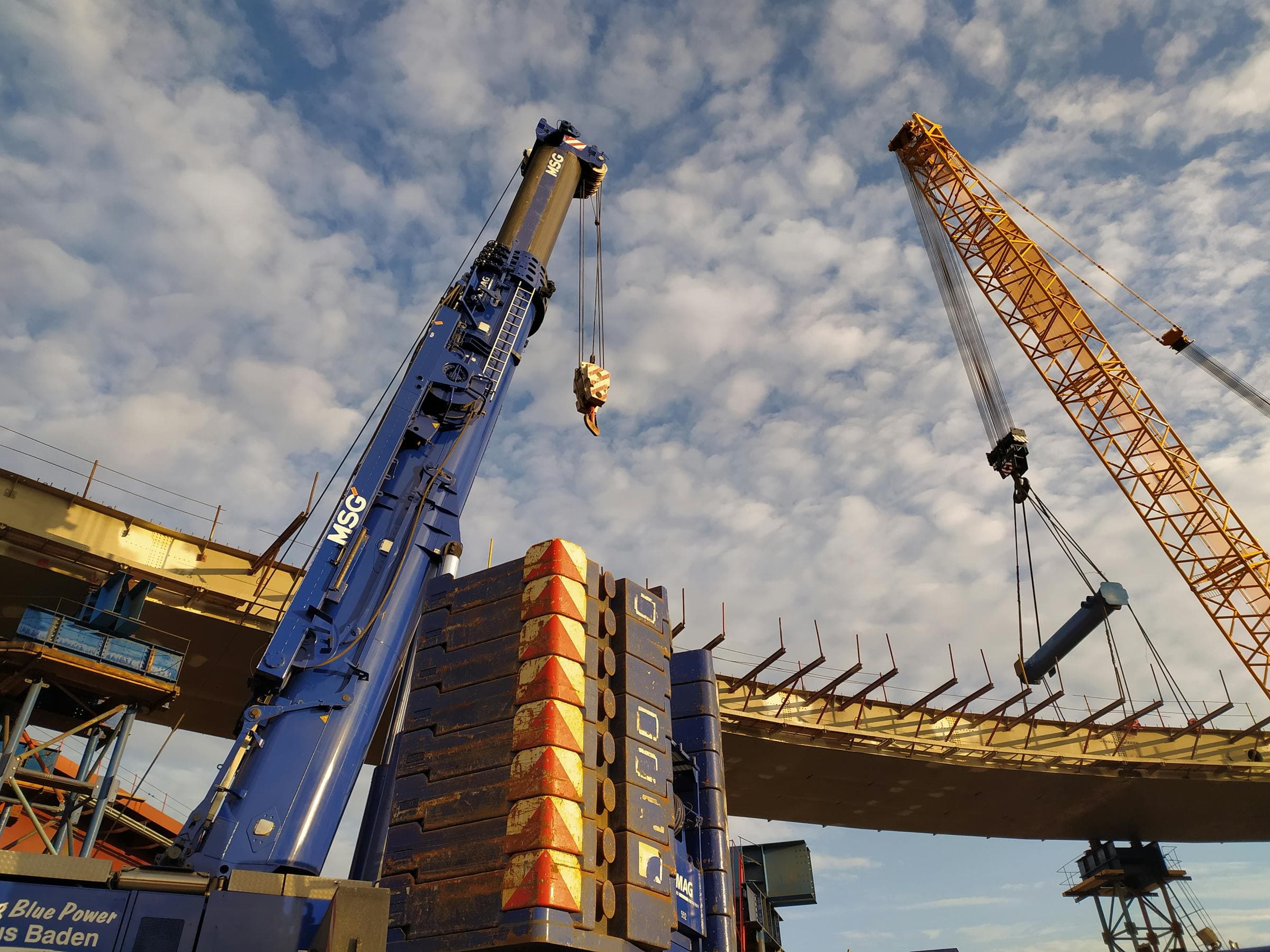 Construction cranes over a stalled data-center build site